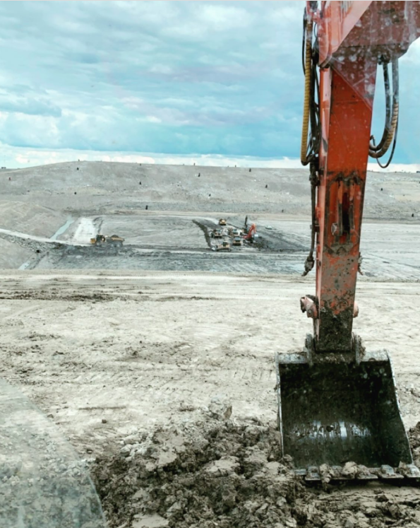 Excavator bucket overlooking large earthworks excavation, submitted by Donny Campbell
